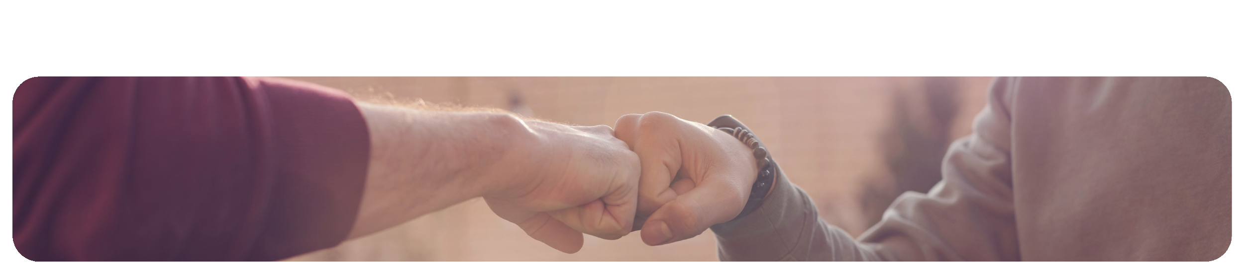 A youth leader and student fist bumping